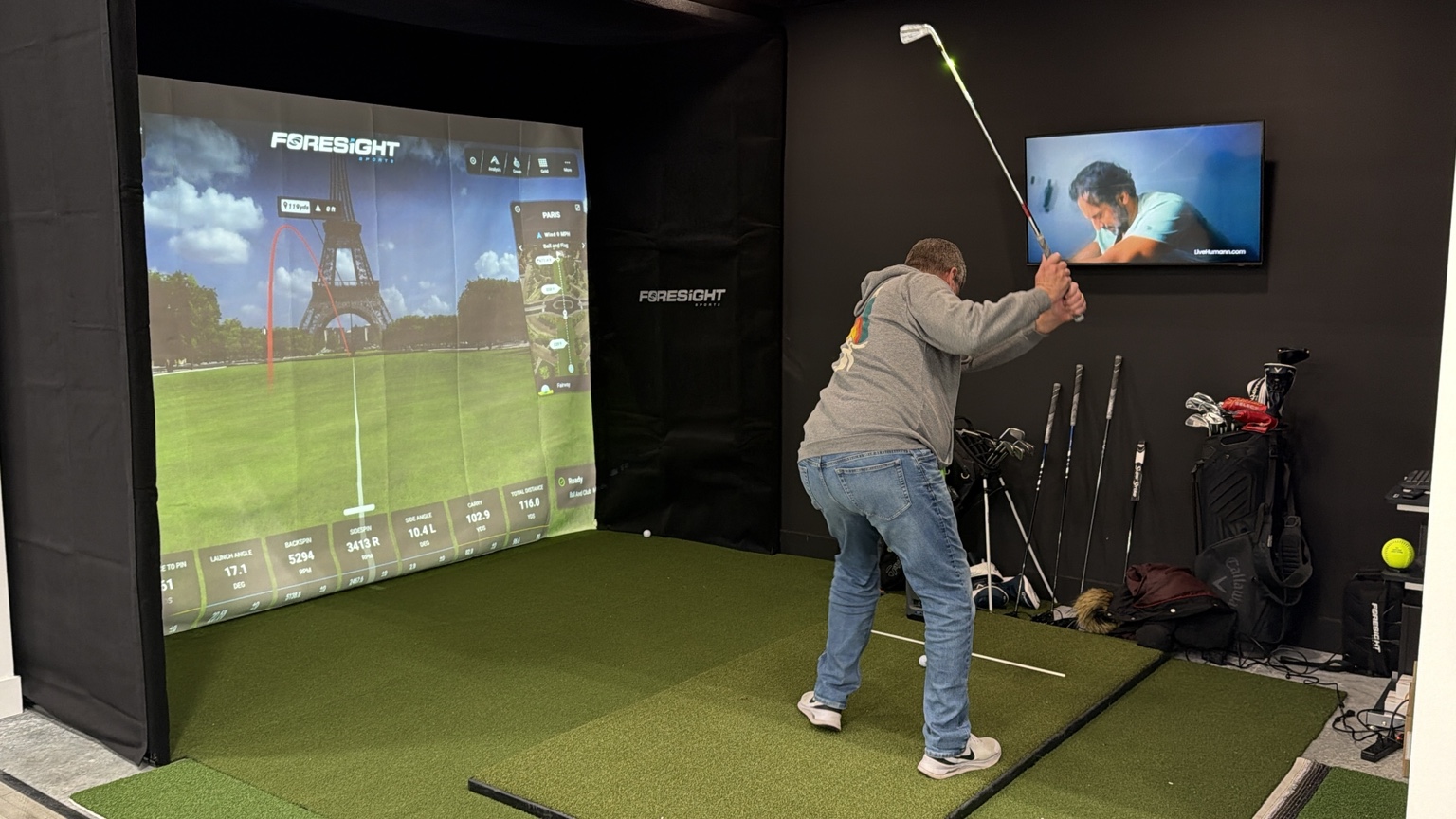 Golfer using the private Foresight golf simulator