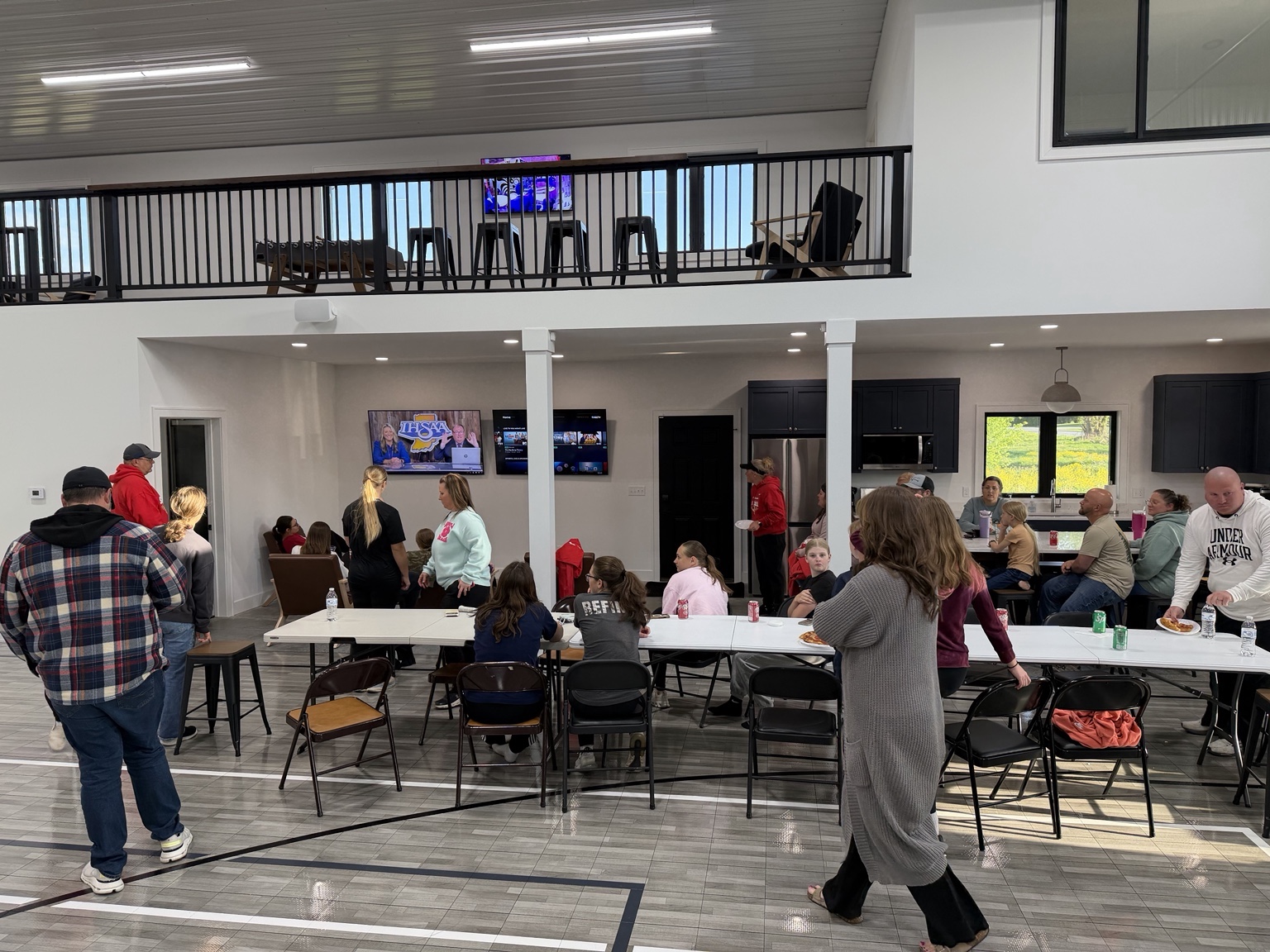Families and guests gathering in the court-side kitchen and entertainment area