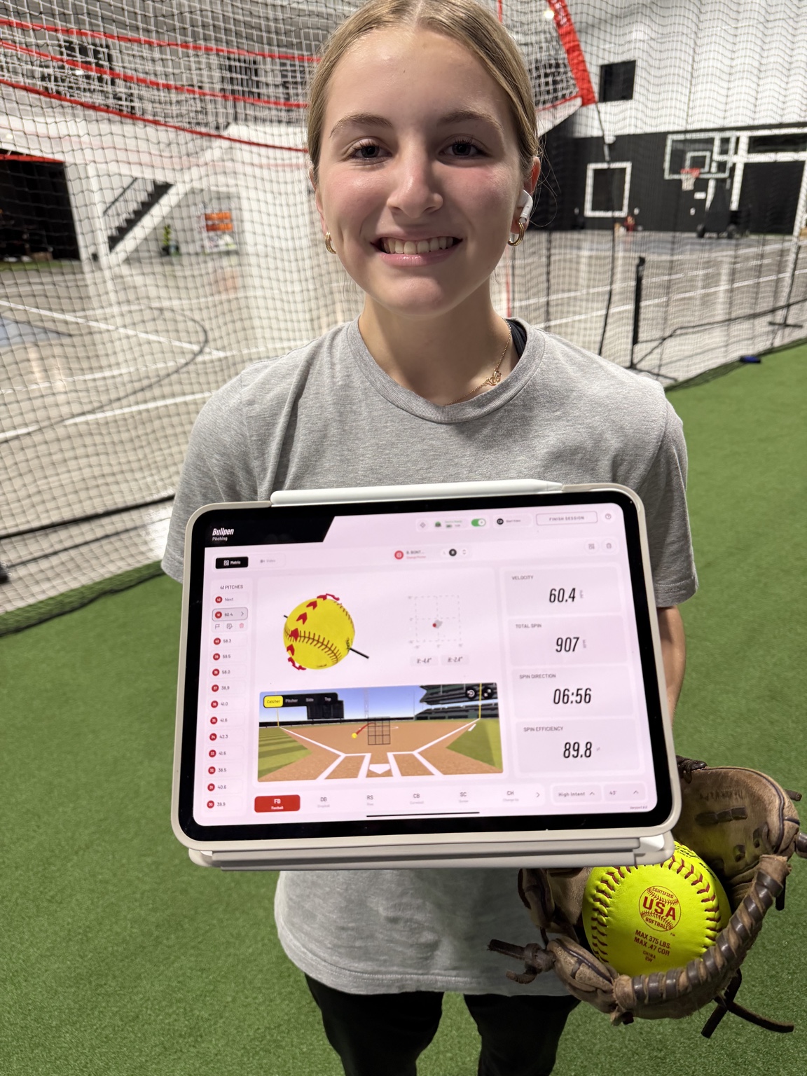 Softball pitcher displaying Rapsodo pitching analytics